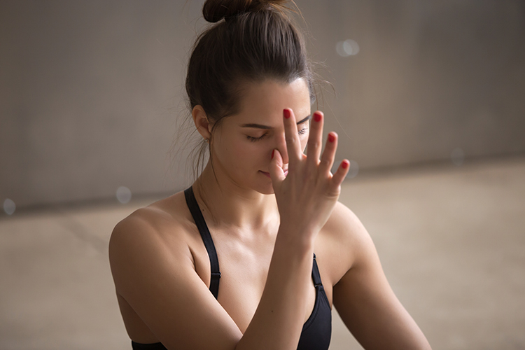 Person practicing alternate nostril breathing